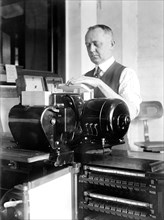 Man working tabulating machine at the Census bureau circa 1919.