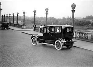 Car crossing a bridge in Washington D.C. circa 1919.
