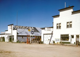 Photograph shows Sign on pole: Calso; sign above double doors: Baker's Garage. Wisdom Montana April 1942.
