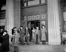 Men standing in front of and exiting the Securities and Exchange Commission circa 1937.