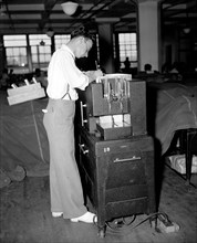 Social Security Board Records Office - Man working gang punch machine (punch card machine) circa 1937.