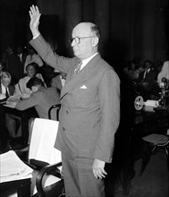 Man taking oath to tell the truth before a Senate committee circa 1937 .