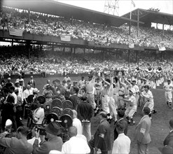 Players from both Major League All-Star teams stage a mad scramble to the first ball pitched by President Roosevelt to start the 1937 game today. Joe Moore, N.Y. Giants outfielder, caught the much cov...