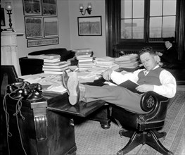 1/26/1938 - Democrat Senator Allen J. Ellender, of Louisiana, rests and studies up on Senate procedure of filibuster while his colleagues continue the Filibuster against the anti-lynching bill circa 1...