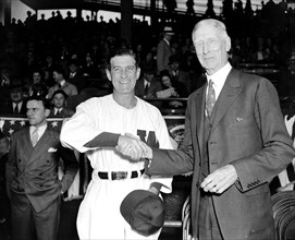 Bucky Harris and Connie Mack shake hands before their teams went into action to pry the lid off the 1938 baseball season circa April 1938.
