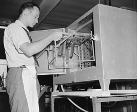 A National Bureau of Standards worker conducting experiement to help with movie film preservation circa 1938.