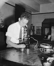 A National Bureau of Standards worker conducting experiement to help with movie film preservation - resistance testing circa 1938.