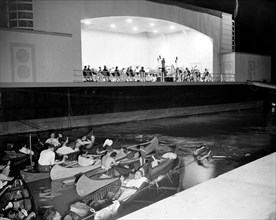 People in canoes listening to the National Symphony Orchestra circa 1938 .