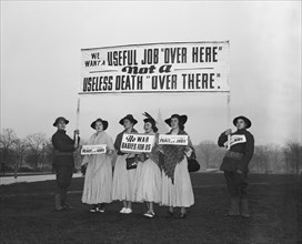 Anti-war protesters against World War II holding signs circa 1940 .