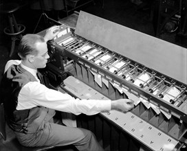 Man working Card sorter for tabulating machine circa 1940.