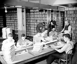 Employees in the patent office file room circa 1940.