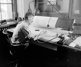 Map-making Division of Coast & Geodetic Survey, Dept of Commerce, cartographer during map making process circa 1940 .