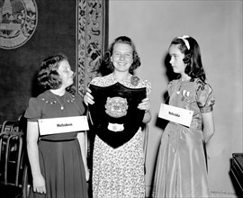 Children with plaque 'The Courier-Journal Spelling Bee; Trophy 1940'.