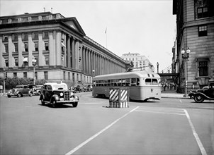 Cars and bus on Pennsylvania Avenue and 15th Street in Washington D.C. circa July 1936.