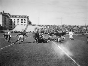 Running back Bunch, (carrying the ball) starred for the plucky William & Mary eleven as they took a trouncing from Navy here today in the opening of the football season 9/25/1936.
