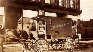 Horse-drawn delivery cart for Stover and Sager's store in Deseronto, outside the store circa 1910.