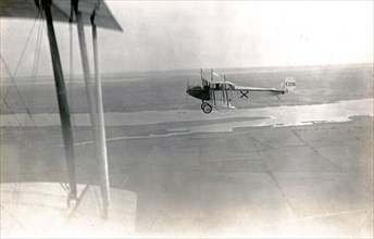 Aerial photograph of Curtiss JN-4 aircraft number C126, taken over open fields and the Bay of Quinte circa 1917.