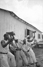 Lightnin'' Washington, an African American prisoner, singing with his group in the woodyard at Darrington State Farm, Texas circa April 1934.