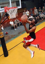 2006 - A U.S. Navy Information System's Technician Second Class, participates in a basketball slam dunk competition while assigned at Naval Computer Telecommunications Area Master Station, Atlantic, D...