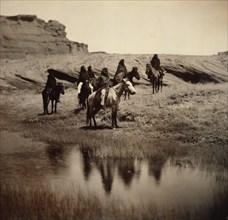 Edward S. Curits Native American Indians - Six Navajo on horseback, water in foreground circa 1904.