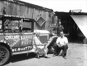 Woman and man next to automobile, participants for the Bonus protest: Orlando to Washington, Bonus or Bust circa 1932.