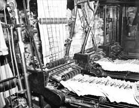 Newspapers coming off press circa March 1936.