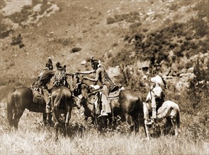 Edward S. Curtis Native American Indians -  Crow men on horseback apparently involved in an exchange circa 1905.