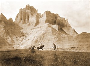 Edward S. Curtis Native American Indians - Entering the Bad Lands. Three Sioux Indians on horseback circa 1905.