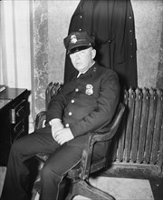 Fred. C. Parker, alleged life threatener of Sen. Huey Long, as he appeared at his post of duty in the House office building where he works as a member of the Capitol police force circa February 8, 193...