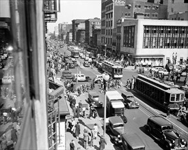 Streetview of Washington D.C. with busy traffic of cars and streetcars circa 1935.