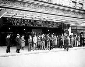 Customers outside of a theater in Washington D.C. circa 1936.