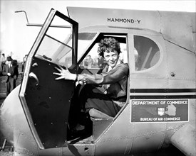 Amelia Earhart in airplane, looking at camera  circa 1936.
