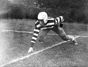 Woodrow Sayre, son of Francis (State Dpt.) Sayre, and grandson of the late President, Woodrow Wilson, photographed in his football outfit at St. Albans School, Washington circa 10/12/1935.