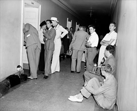 Photographers in hallway waiting circa 1936.