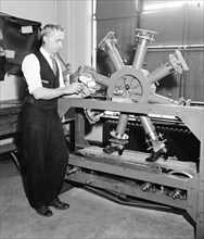 U.S. Government Waste - E.L. Wallace, acting Chief of the Leather Section of the Bureau of Standards, shown with the endurance shoe tester circa 10/24/1935 .