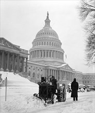 Man plowing snow with tractor on December 30, 1935 in front of the United States Capitol in winter.