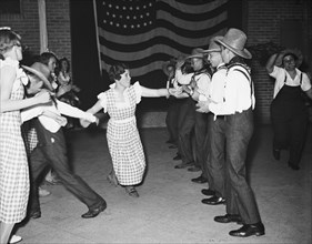 Men and women dancing (probably a square dance) circa 1934.
