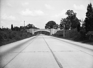 Empty road with bridge in background circa 1934.