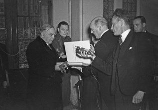 William Lyon Mackenzie King, Prime Minister of Canada, in the City Hall in Amsterdam. Handing over a book Date November 19, 1947 / Location Amsterdam, Noord-Holland.