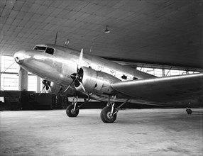 Passenger airplane circa 1936 inside a hangar.