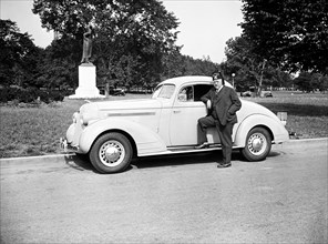 Shriner L.P. Steuart standing by car circa 1935.