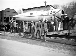 The Winnie Mae, famous globe circling plane with carried the late Wiley Post around the world solo is unloaded at Bolling field, Washington, under the direction of Smithsonian Institution circa 12/2/1...