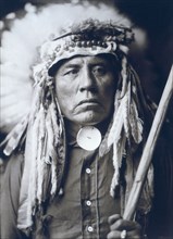 Edward S. Curtis Native American Indians - Apsaroke man, half-length portrait, wearing headdress circa 1905.