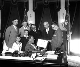Franklin D. Roosevelt - PRESIDENT ROOSEVELT at his desk RECEIVES LUTHERAN STAMPS circa 1933.