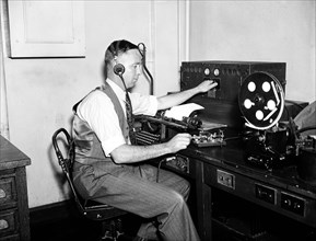 Man listening to radio circa 1936.