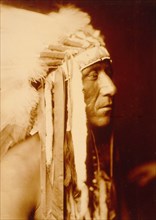 Edward S. Curtis Native American Indians - Pretty Paint, Crow man, head-and-shoulders portrait circa 1905.