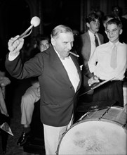 Congressional musicians, gave the House a treat last night, by playing a number of old tunes. Congressman playing a drum and smoking cigar 8/27/35.