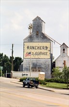 July 2001 - Pick up truck on highway through downtown Lusk Wyoming  - Rancher's Feed Service Silo.