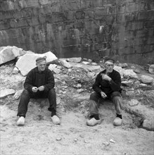 Zeeland series - Two men wearing wooden shoes taking a rest outdoors circa October 23, 1947.