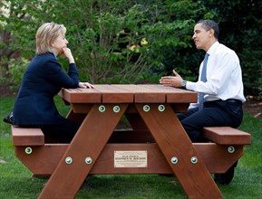 President Barack Obama and Secretary of State Hillary Rodham Clinton speak together sitting at a picnic table April 9, 2009, on the South Lawn of the White House. .